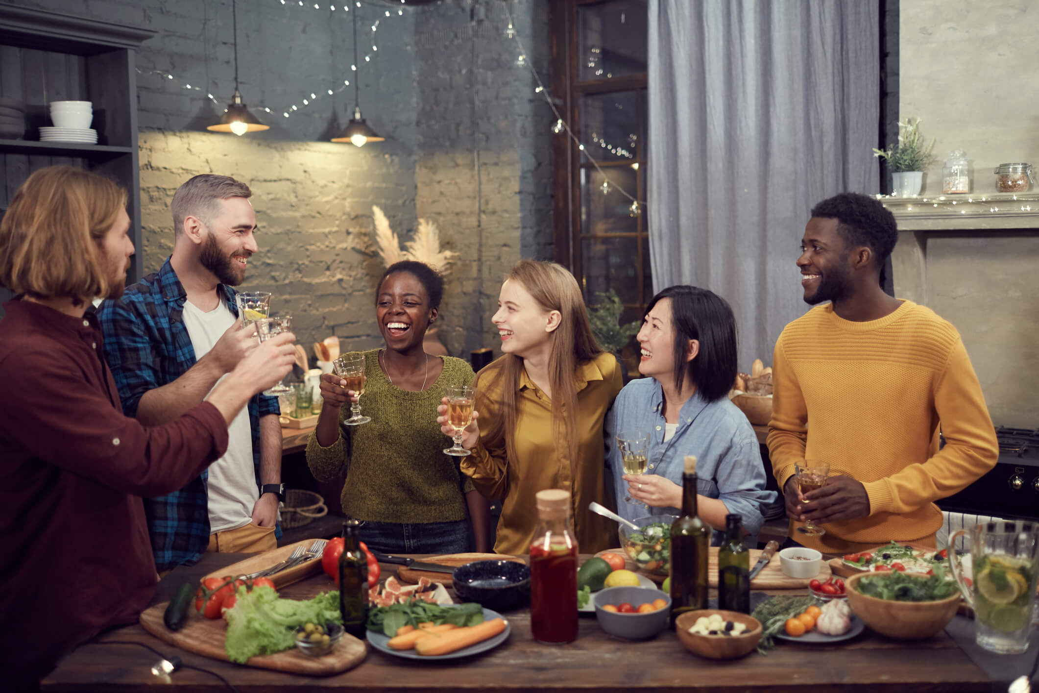 Smiling friends gathered together for dinner